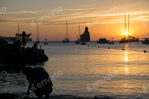 Preview: Ibiza Balearic Islands Spain On June 19, 2019 Benirras Beach At Sunset Mediterranean Sea.