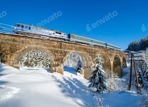 Preview: Stone Viaduct (Arch Bridge) On Railway Through Mountain Snowy Fir Forest. Snow Drifts On Wayside