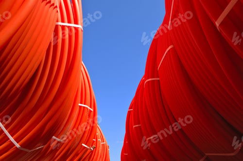 Preview: Plastic Pipes Stacked In Rolls On The Street On The Sky Background