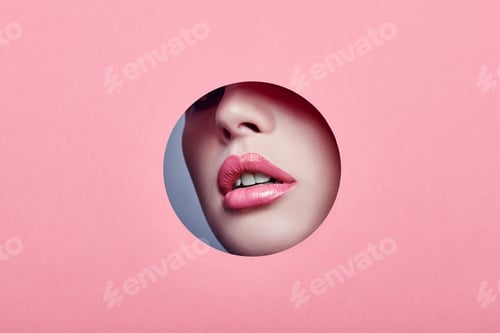 Preview: Beautiful Plump Lips Bright Pink Color, Woman Looks In Hole Colored Pink Paper, Beauty Salon