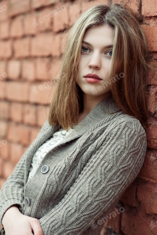 Preview: Portrait Of Sad Female Standing Against The Wall