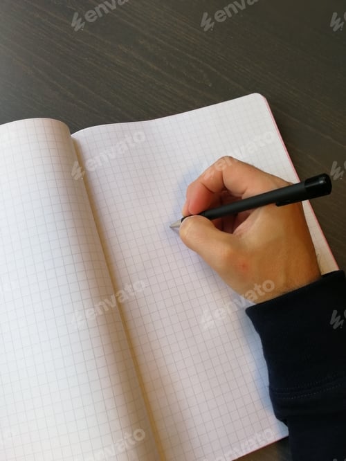 Preview: Caucasian Man Is Writing On A Notepad. Empty Notepad Page