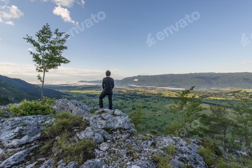 Preview: Man Standing At The Top Of The Hill And Taking Photos Of The Picturesque Valley Below. Vivid Colors
