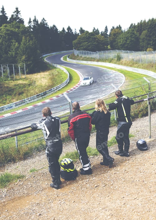 Preview: A Group Of Friends Watching A Car Race On A Legendary Racing Track In Germany. People Are Watching
