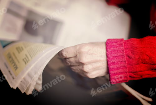 Preview: An Elderly Woman Is Reading A Newspaper. Image Has A Vintage Effect.