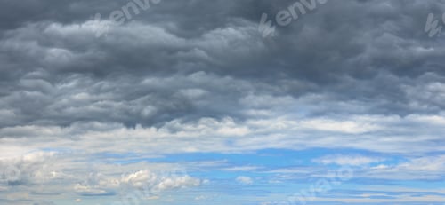 Preview: Summer Weather Changing Overcast Sky Background. Overcast Rainy Clouds Over Blue Azure Sky.