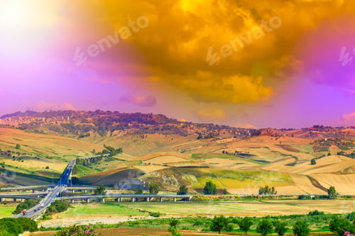 Preview: Landscape Of Sicilian Hills At Sunrise. Asphalt Road Elevated By Columns Due Of Frequent