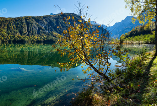 Preview: Sunny Idyllic Colorful Autumn Alpine View. Peaceful Mountain Lake With Clear Transparent Water And