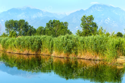 Preview: Summer Morning Misty Mountain Landscape With Water Surface In Front (Greece)