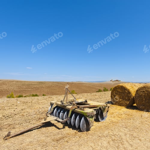 Preview: Landscape With Harrow On The Plowed Field In Italy. Hay Bales On The Plowed Hills Of Tuscany In The