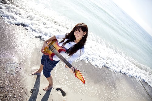 Preview: Pretty Young Woman With Guitar On Beach