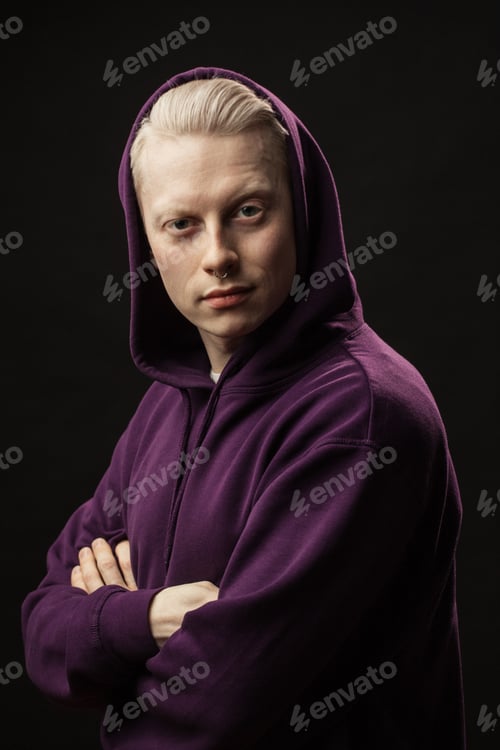 Preview: Handsome Blonde Male Model Dressed In Purple Spotrshirt Looking Pencively At Camera Posing With
