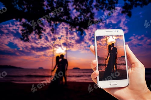 Preview: Couple In Love At Sunset. Beach. Palms. The Photo Is Taken With Telephone