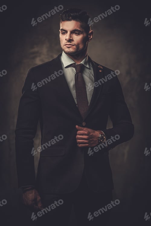 Preview: Serious Well-Dressed Hispanic Man Posing On Dark Background.