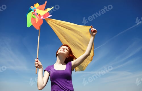 Preview: Young Girl With Wind Turbine At Rapeseed Field.