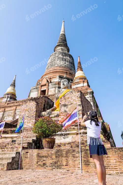 Preview: Tourist Teenage Girl Standing Take A Photo Of Buddha Statue And Ancient Pagoda On Blue Sky