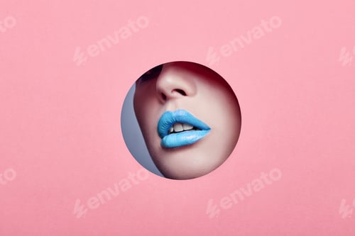 Preview: Beautiful Plump Lips Bright Blue Color, Woman Looks In Hole Colored Pink Paper, Beauty Salon