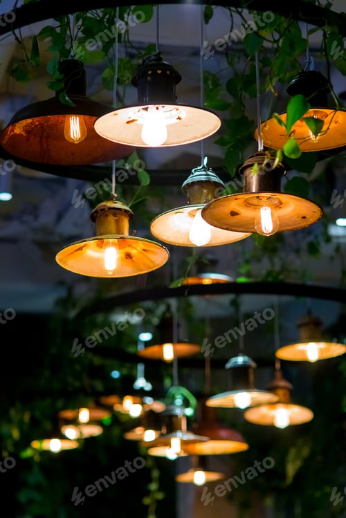 Preview: Several Round Loft Style Suspended Luminaires With Edison Lamps Shine A Warm Light In Interior Of A