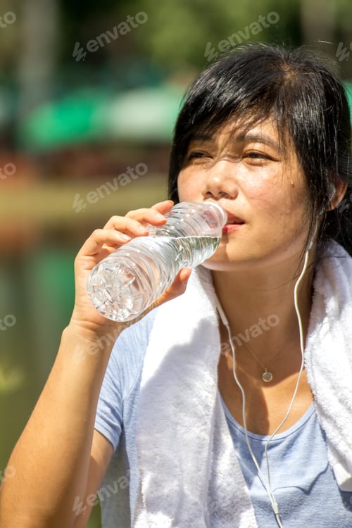 Preview: The Asian Woman With White Towel Is Drinking Fresh Water From The Plastic Bottle After Her Working