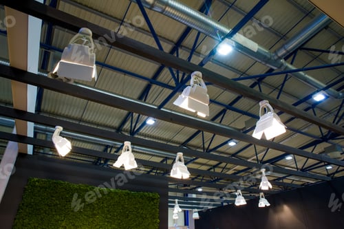 Preview: Architectural Lighting on a Blue Grid Patterned Ceiling