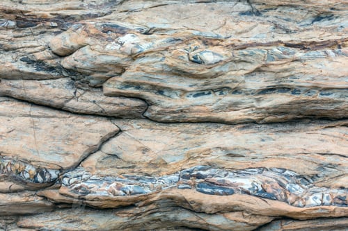 Preview: Part Of Rock Close Up With Impregnation Multicolored Rock In Form Of Snake. Nature Background.