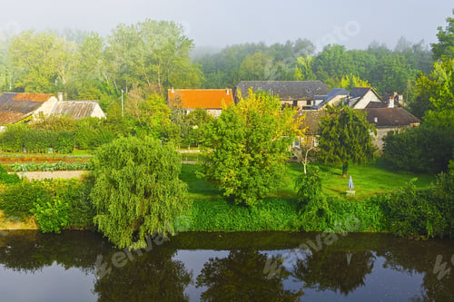 Preview: Small French Village On The River Bank In The Morning Mist
