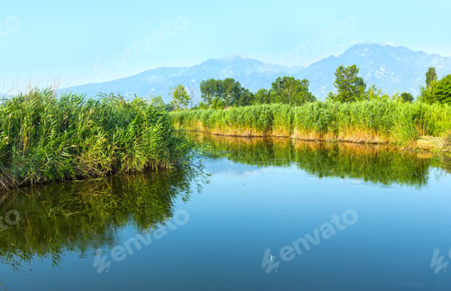 Preview: Summer Morning Misty Mountain Landscape With Water Surface In Front (Greece).
