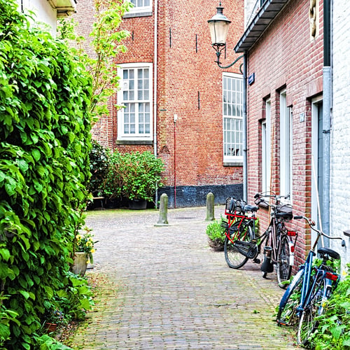 Preview: Typical Dutch Brick Houses In Holland. Street View With Bikes Parked In The Historical Center Of