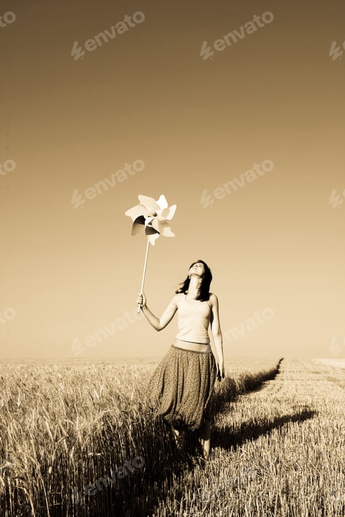 Preview: Girl With Toy Wind Turbine At Field In Retro Style