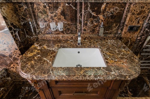 Preview: Ceramic White Washbasin In Furniture With Stone Surface In Marble Bathroom