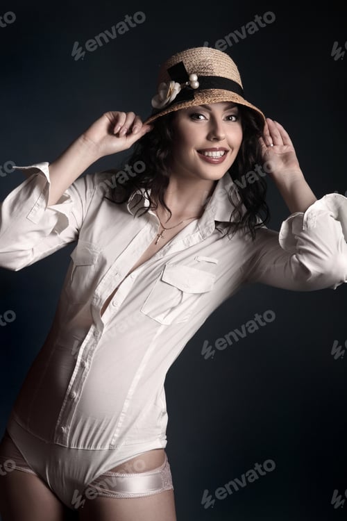 Preview: Woman Poses with Hat in Studio Setting