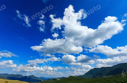 Vorschau: Wunderschöner blauer Himmel mit weißen Cumuluswolken über den Sommerkarpaten (Ukraine).