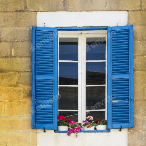 Preview: Building With Traditional Maltese Window Decorated With Fresh Flowers In Valletta.