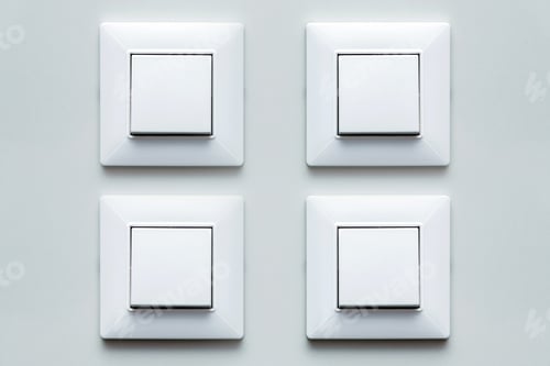 Preview: A Few Light Switch, Four Plastic Mechanical Buttons Of White Color Installed On A Light Wall.