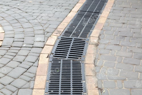 Preview: A Lattice Of A Drainage Paving System With Hatch Grill On A Curve Path Made Of Stone Tiles, Close