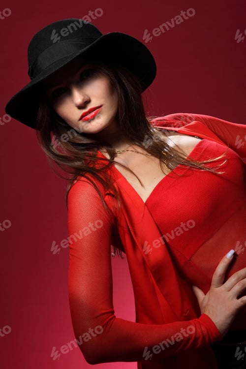 Preview: Beautiful Woman In A Hat On A Red Background. Flirty Look. Game Emotions.