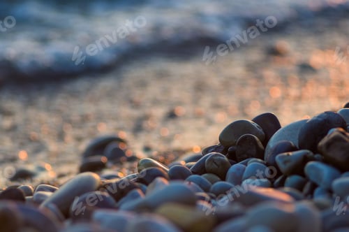Preview: Pebble Stones On The Sea Beach On A Warm Summer Day, The Rolling Waves Of The Blue Sea With White