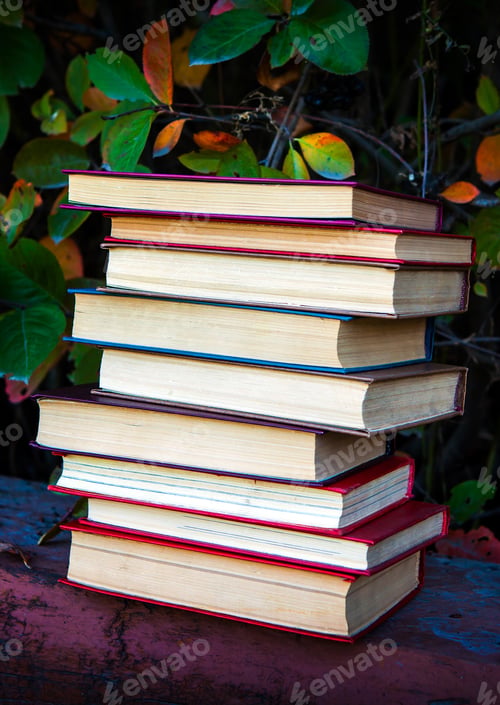 Preview: Pile Of The Old Books On The Leaves Background Closeup