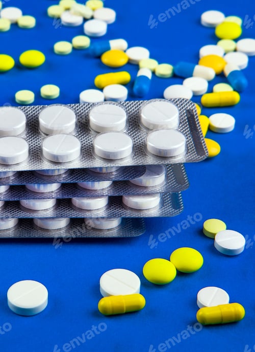 Preview: Pills On The Blue Paper Background Closeup