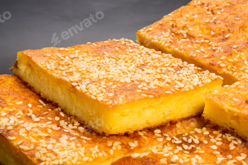 Preview: Slice Of Cheesecake With Sesame Seeds On A Black Background