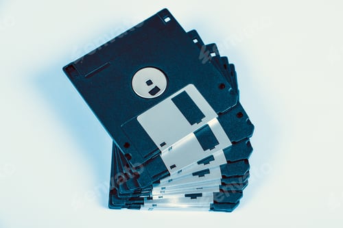 Preview: Toned Photo Of Floppy Disks Drive Set On The Paper Background Closeup