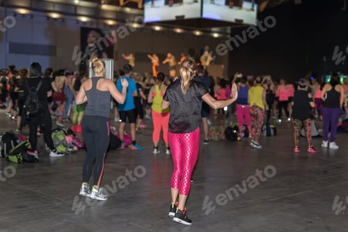 Preview: Fitness Workout In Gym: People Doing Exercises In Class With Music And Teacher On Stage.