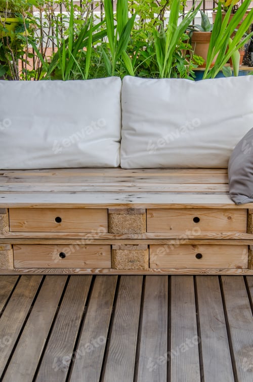 Preview: Wooden Pallet Couch On Balcony With Plants In Background