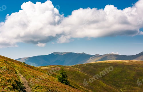 Preview: Mountain Ridge Behind The Rolling Hills Under The Blue Sky With Huge Cloud. Wonderful Weather On