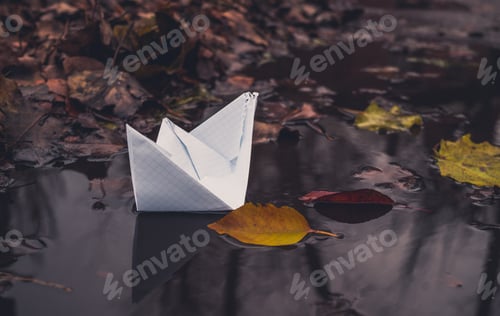 Preview: White Paper Boat And Fallen Autumn Leaves. Autumn Sadness