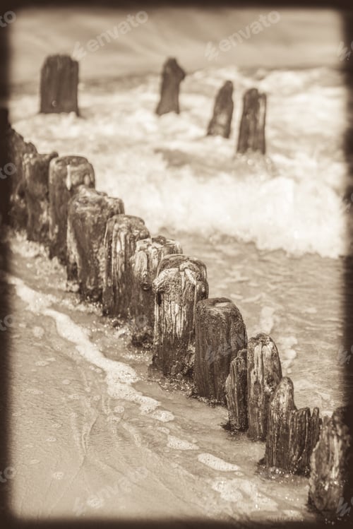 Preview: Retro Vintage Sepia Image Of An Old Wooden Breakwaters On The Baltic Coast Beach