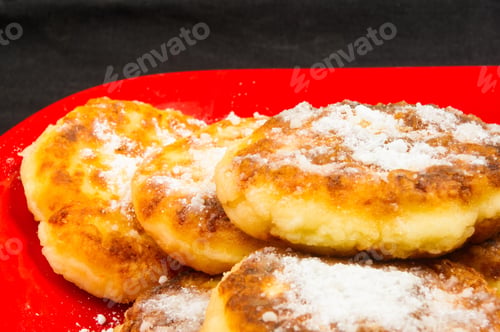 Preview: Red Plate Of Pancakes In Powdered Sugar On Black Background