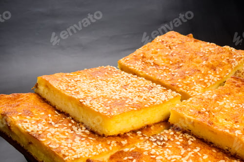 Preview: Slice Of Cheesecake With Sesame Seeds On A Black Background
