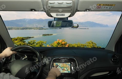 Preview: Driving A Car While Using The Touch Screen Of A Gps Navigation System Towards Lake Garda, Italy