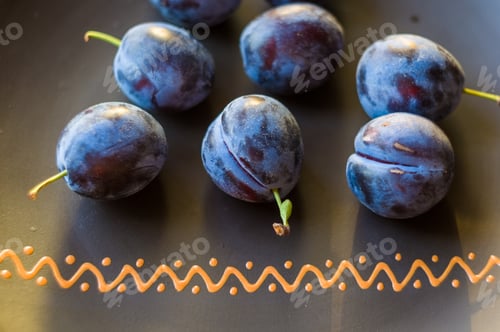 Preview: Juicy Blue Plums In Ceramic Plate On Wooden Background